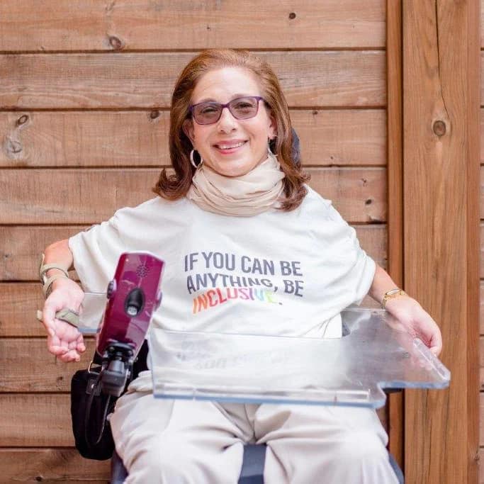 One of Sheri's photos from her professional shoot with a T-shirt that says, "If you can be anything, be inclusive," 7-22.