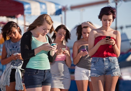 Young people engrossed in their phones.