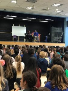 Happy on Wheels speaking at an elementary school