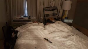 People sleeping sideways on a bed