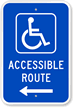 Sign with the handicap symbol and an arrow pointing to an accessible route.