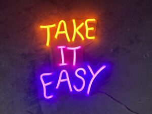 Graphic of a neon sign that says "Take It Easy."