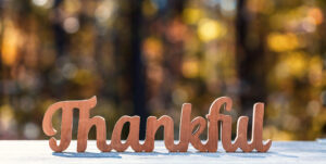 Carved sign that reads "Thankful."