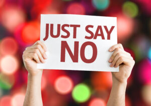 Person holding a sign that reads "Just say no."