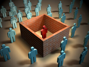 A graphic showing on person separated by brick walls from other people.