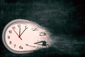 Concept picture that shows a clock that is dissolving into little particles.