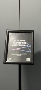 A photo of a sign in front of the elevator at Artechouse saying it is "Closed for Maintenance."