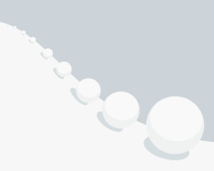 Picture of the 'snowball effect': a snowball getting bigger and bigger as it rolls down a hill.