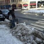 Snow and slush blocking a curbcut.