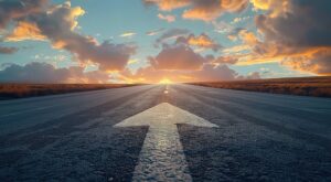 A straight road leading into the distance with an arrow pointing forward on it