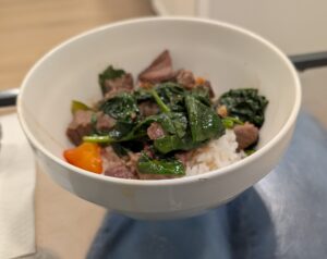 Beef stir-fry on rice .